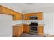 Bright kitchen featuring stainless steel appliances, granite countertops, and classic wood cabinets at 6614 Truman St, Indian Trail, NC 28079