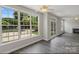 Open living room featuring large windows, a fireplace, and access to the outside at 6614 Truman St, Indian Trail, NC 28079