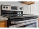 Stainless steel stove with black top, white tiled backsplash, and granite counter top at 6614 Truman St, Indian Trail, NC 28079