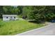 Charming single story cottage-style home with a small porch and a lush green lawn at 6649 Mountain Grove Rd, Hickory, NC 28602