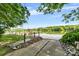 Concrete boat ramp leading down to the water with wooden pier at 6822 Zelda Dr, Catawba, NC 28609