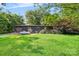 Front exterior of home featuring a large yard and garage with mature trees at 6822 Zelda Dr, Catawba, NC 28609