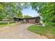 Charming exterior view of a home featuring a log-cabin exterior, garage, and well-manicured lawn at 6822 Zelda Dr, Catawba, NC 28609