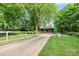 Exterior view of a home featuring a long driveway, fence, mature trees, and a peaceful setting at 6822 Zelda Dr, Catawba, NC 28609