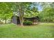 Wood cabin showcasing its exterior with lush greenery and well-maintained lawn at 6822 Zelda Dr, Catawba, NC 28609