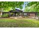 Charming log cabin with a cozy front porch and well-maintained landscaping at 6822 Zelda Dr, Catawba, NC 28609