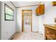 Bright mudroom with wood cabinets, a window, and a door with curtain at 6822 Zelda Dr, Catawba, NC 28609