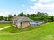 Aerial view of the clubhouse and the pool surrounded by a manicured lawn and green trees at 7325 Overmountain Dr, Rock Hill, SC 29732