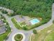 Aerial view of the community pool and surrounding amenities in a lush green neighborhood at 7325 Overmountain Dr, Rock Hill, SC 29732