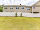 Spacious backyard with a well-maintained lawn and secure white fencing, ideal for outdoor activities at 7325 Overmountain Dr, Rock Hill, SC 29732