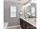 Bathroom featuring a double vanity with a large mirror and neutral decor at 7325 Overmountain Dr, Rock Hill, SC 29732