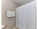 This is a bathroom with a bathtub and shower with white shower curtains and a towel rack with towels at 7325 Overmountain Dr, Rock Hill, SC 29732