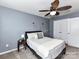 Serene bedroom with a ceiling fan, soft carpet, and a comfy bed with decorative flower accents on the wall at 7325 Overmountain Dr, Rock Hill, SC 29732
