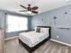 Cozy bedroom featuring a ceiling fan, plush carpet, and a comfortable bed with floral wall decor at 7325 Overmountain Dr, Rock Hill, SC 29732