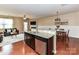 Open kitchen view showcasing granite countertops, stainless steel appliances, and hardwood flooring at 7325 Overmountain Dr, Rock Hill, SC 29732