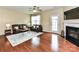 Inviting living room featuring a fireplace, ceiling fan, and comfortable leather furniture at 7325 Overmountain Dr, Rock Hill, SC 29732