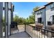 A balcony with black railings offers a view of townhomes, trees, and a private garage at 743 Anderson St, Charlotte, NC 28205