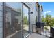 Townhome balcony boasts a sliding glass door and sleek black railings overlooking green foliage at 743 Anderson St, Charlotte, NC 28205