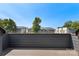 Balcony with composite decking overlooks lush trees and neighborhood rooftops against a clear blue sky at 743 Anderson St, Charlotte, NC 28205