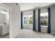 Bright bedroom with big windows, blue curtains, and neutral carpet flooring at 743 Anderson St, Charlotte, NC 28205