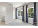 Cozy bedroom with three large windows and neutral carpet flooring at 743 Anderson St, Charlotte, NC 28205
