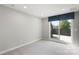 Grey carpeted bedroom featuring a glass sliding door to deck at 743 Anderson St, Charlotte, NC 28205