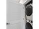 Conveniently located laundry area features a stacked washer and dryer with a modern, louvered door at 743 Anderson St, Charlotte, NC 28205