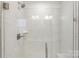 Close-up of a walk-in shower with marble-like tile surround at 743 Anderson St, Charlotte, NC 28205