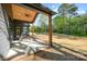 Covered patio with ceiling fan offers an outdoor living space overlooking expansive, grassy backyard at 919 Village Lake Dr, Monroe, NC 28110