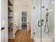 Bright bathroom with an open shower, modern fixtures, and an open doorway to a main bedroom at 919 Village Lake Dr, Monroe, NC 28110