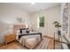 Bright bedroom boasts wood floors, neutral decor, and a plush bed with decorative pillows and throw at 919 Village Lake Dr, Monroe, NC 28110