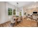 Dining room featuring large windows providing natural light, stylish pendant lighting, and hardwood floors at 919 Village Lake Dr, Monroe, NC 28110