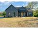 Charming single Gathering home featuring a craftsman style elevation, well manicured lawn and inviting front porch at 919 Village Lake Dr, Monroe, NC 28110