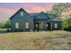 Charming single Gathering home featuring a craftsman style elevation, well manicured lawn and inviting front porch at 919 Village Lake Dr, Monroe, NC 28110