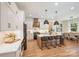 Modern kitchen featuring stainless appliances, a stylish island with a breakfast bar and hardwood floors at 919 Village Lake Dr, Monroe, NC 28110