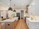 Well-lit kitchen showcasing a large island with a farmhouse sink, modern appliances, and ample counter space at 919 Village Lake Dr, Monroe, NC 28110