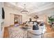 Open concept living room with elegant fireplace and stylish decor with an open view to the kitchen at 919 Village Lake Dr, Monroe, NC 28110