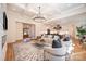 Open concept living room with elegant fireplace and stylish decor with an open view to the kitchen at 919 Village Lake Dr, Monroe, NC 28110