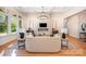 Bright living room with fireplace, elegant lighting fixture, and open concept layout with hardwood floors at 919 Village Lake Dr, Monroe, NC 28110