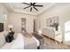 Bright bedroom featuring modern furniture, neutral tones, and large windows overlooking a lush outdoor view at 919 Village Lake Dr, Monroe, NC 28110