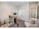 Stylish office area with a glass desk, comfortable seating, a large window, and convenient closet space at 919 Village Lake Dr, Monroe, NC 28110