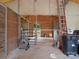 Barn interior with open stalls, a ladder, a metal gate, and storage for tools and supplies at 925 Hamilton Rd, Chester, SC 29706