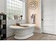 Bright bathroom featuring a standalone tub, decorative fixtures, and wood plank walls at 925 Hamilton Rd, Chester, SC 29706