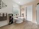 Charming bathroom featuring a standalone tub, decorative fixtures, and wood plank walls at 925 Hamilton Rd, Chester, SC 29706