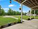 Inviting exterior covered porch decorated with hanging plants, overlooking the well-maintained lawn and surrounding greenery at 925 Hamilton Rd, Chester, SC 29706