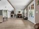 Cozy living room with a stone fireplace, a piano, and French doors leading to the outdoors at 925 Hamilton Rd, Chester, SC 29706