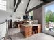 Open loft area with natural light, exposed beams, and wood floors that leads to outdoor seating at 925 Hamilton Rd, Chester, SC 29706