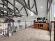Open loft area featuring exposed wood beams, light wood floors, and a railing overlooking the lower level at 925 Hamilton Rd, Chester, SC 29706