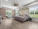 Bright main bedroom featuring light wood floors, large windows, and modern ceiling fan at 925 Hamilton Rd, Chester, SC 29706