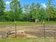 Pastoral scene of a horse shelter in a green field with a hay bale in the foreground at 925 Hamilton Rd, Chester, SC 29706